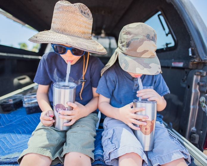 Kids taking a drink in the truck
