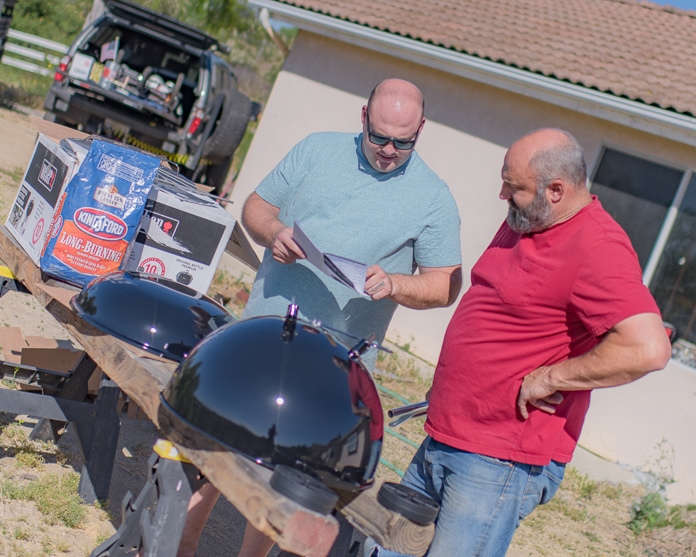 Men putting together a barbecue