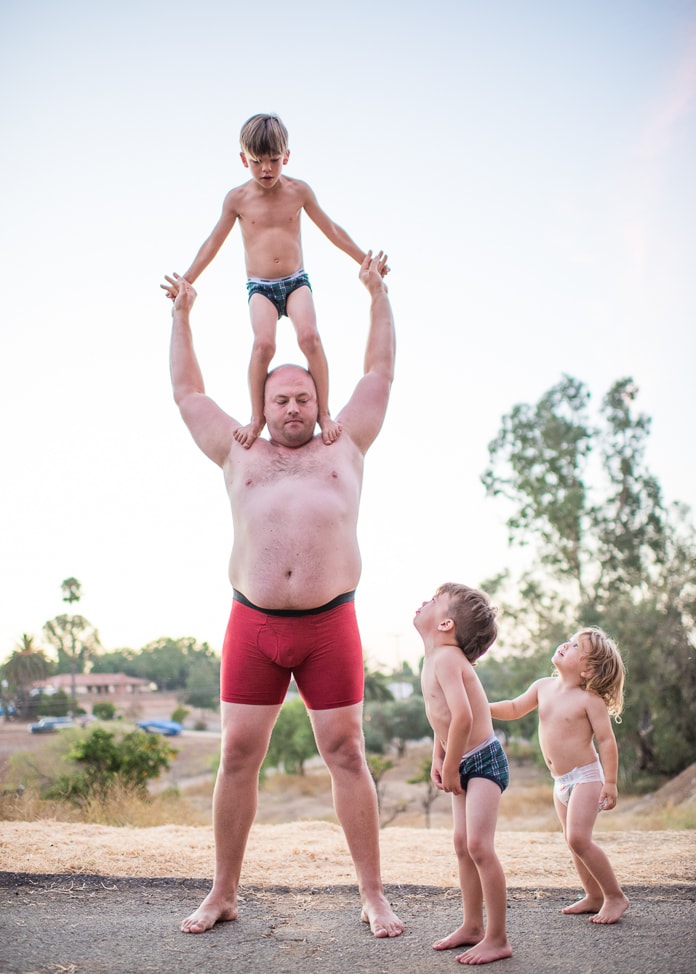Dad doing acrobatics with kids