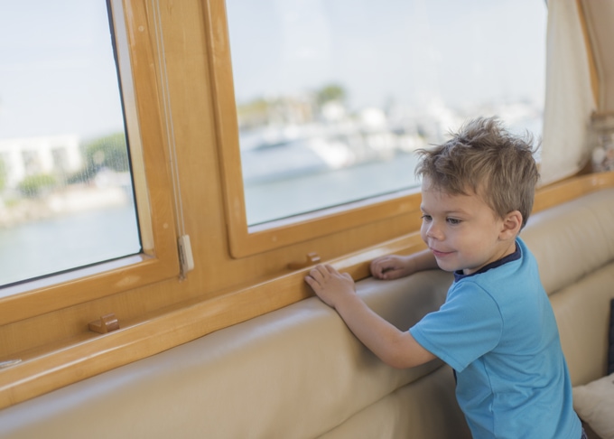 Boy looking out yacht window