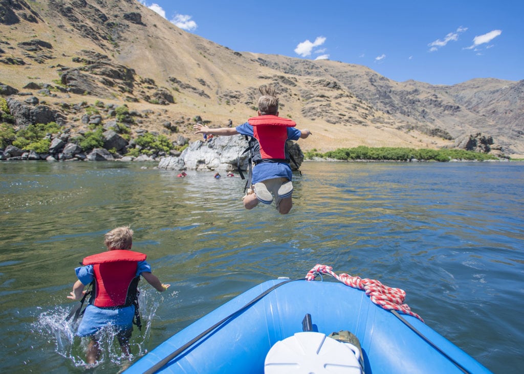 Little boys jump into the snake river after their california exodus