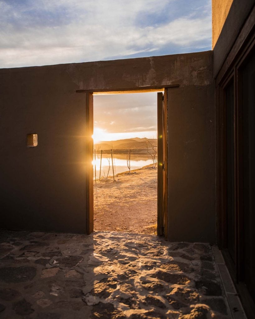 Golden sunrise through the door of the Cibolo Creek Ranch adventure resort