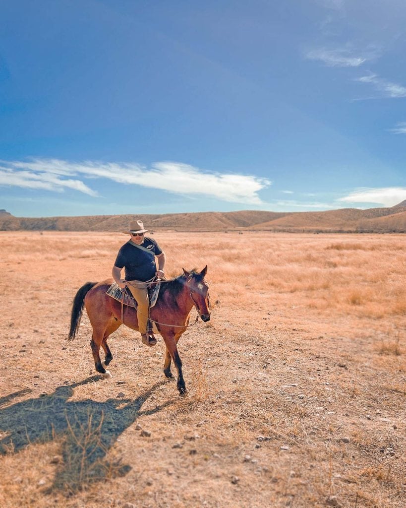 Nate Day riding a horse at Cibolo Creek Ranch adventure resort